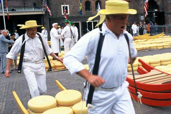 Cheese carriers on market day carrying cheese on a stretcher