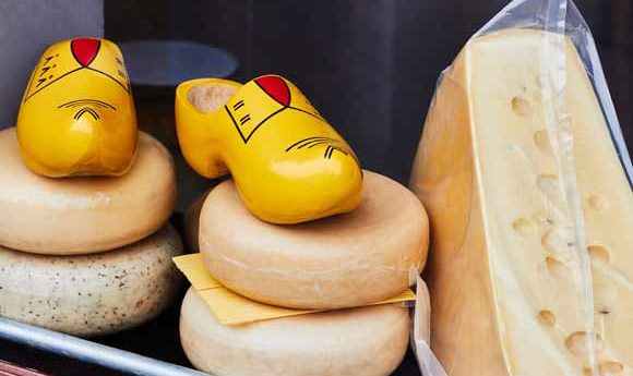 Two traditional Dutch products in a shop window - Clogs and Cheese